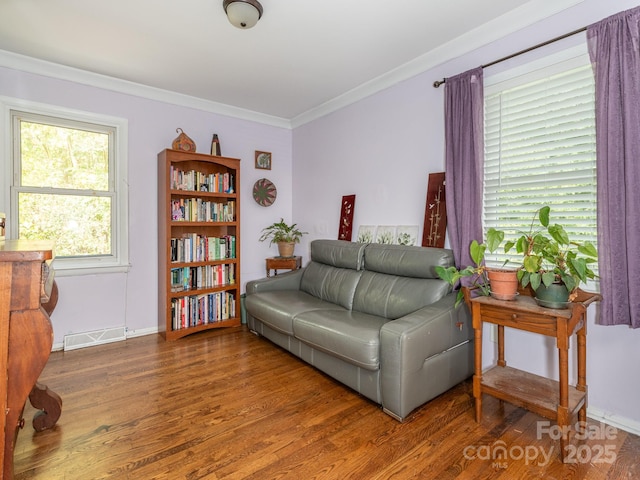 living room with crown molding and hardwood / wood-style flooring