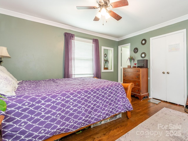 bedroom featuring ceiling fan, ornamental molding, and wood-type flooring