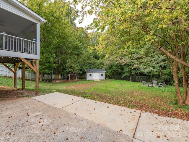 view of yard with a patio area, a sunroom, and a storage unit