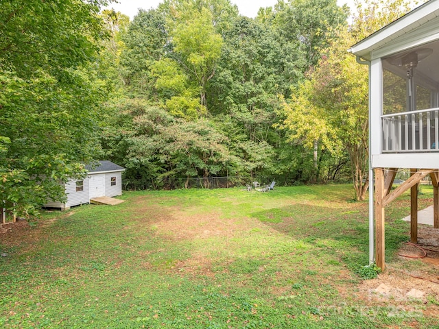 view of yard featuring a shed and a sunroom