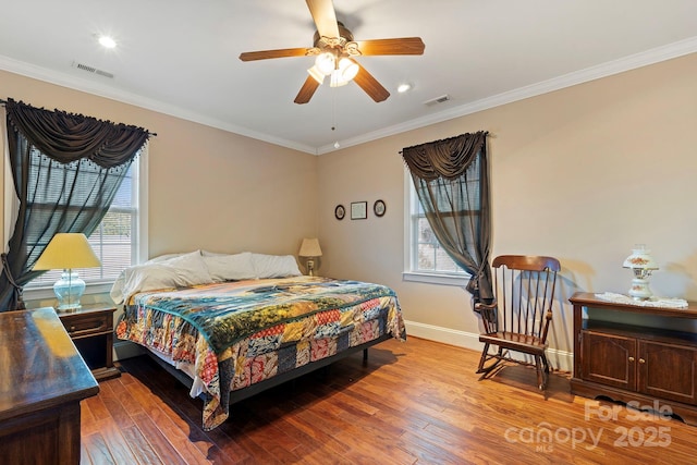 bedroom featuring ceiling fan, ornamental molding, and hardwood / wood-style floors