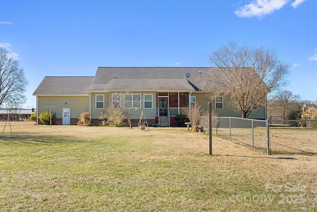 back of property featuring a sunroom and a yard