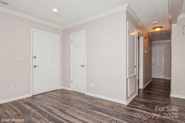 interior space featuring ornamental molding, dark wood finished floors, visible vents, and baseboards