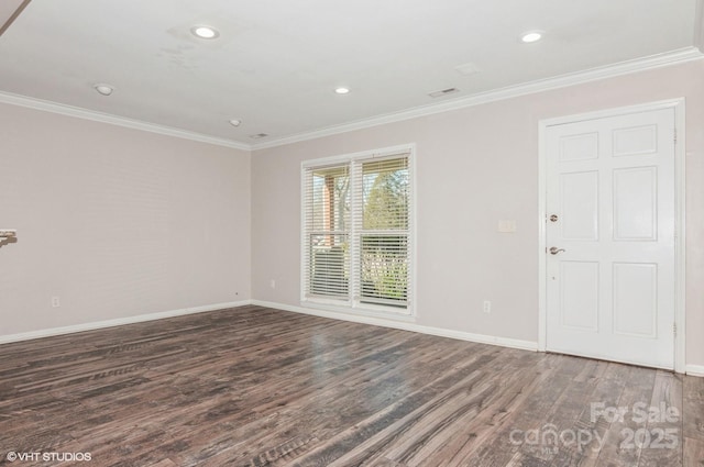 unfurnished room featuring dark wood-type flooring, crown molding, and baseboards