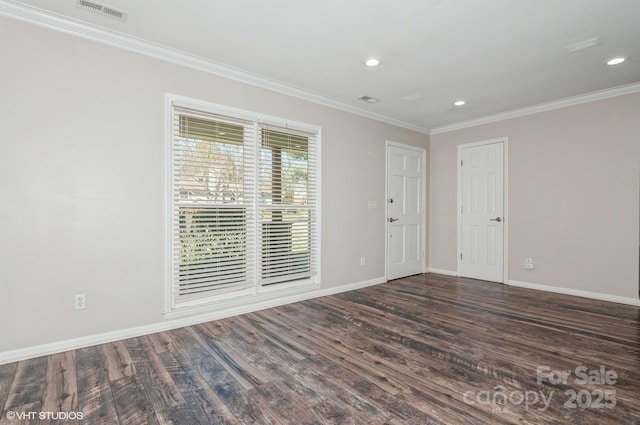 spare room with baseboards, dark wood-type flooring, and ornamental molding