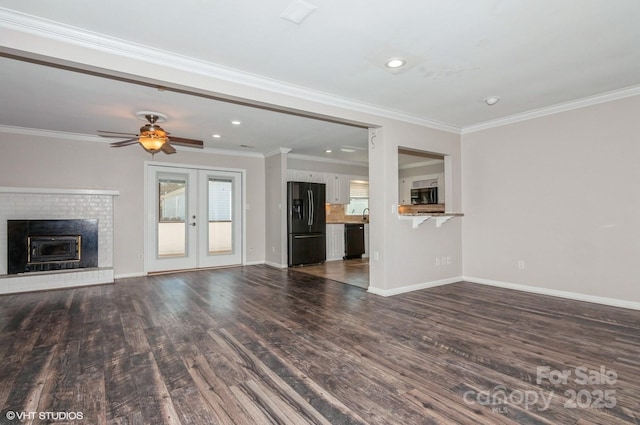 unfurnished living room featuring dark wood-style floors, french doors, ornamental molding, and baseboards