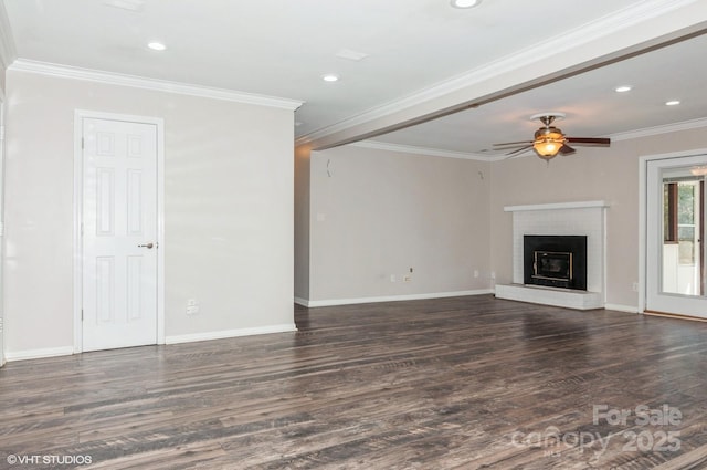 unfurnished living room with dark wood-type flooring, crown molding, a fireplace, and a ceiling fan