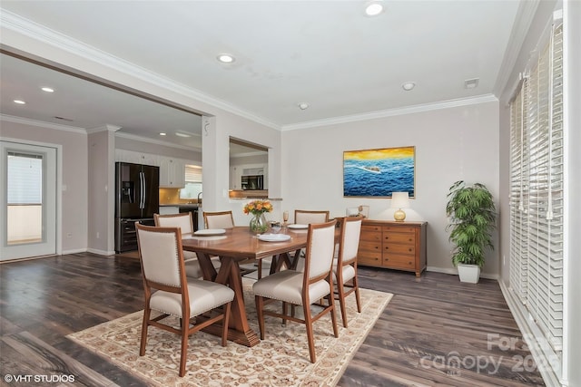 dining space featuring dark wood-style floors, baseboards, and crown molding