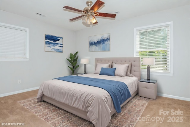 bedroom featuring carpet floors, baseboards, visible vents, and a ceiling fan