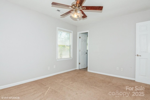 unfurnished room featuring a ceiling fan, carpet flooring, visible vents, and baseboards