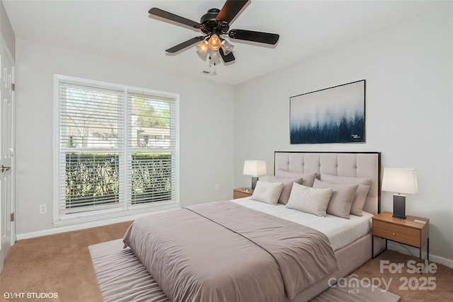 carpeted bedroom featuring visible vents, baseboards, and a ceiling fan