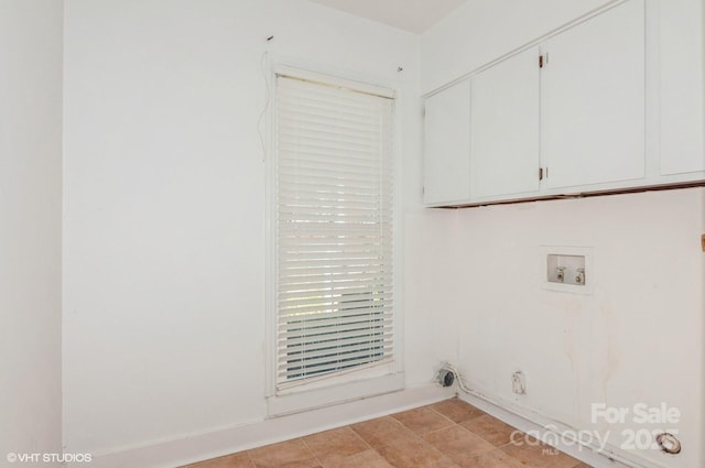 clothes washing area with cabinet space, hookup for a gas dryer, and washer hookup