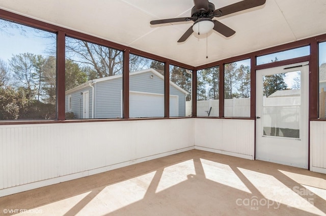 unfurnished sunroom featuring ceiling fan