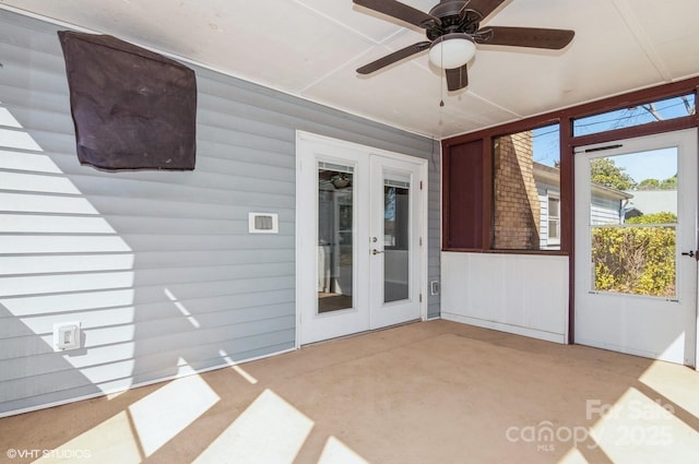 unfurnished sunroom with ceiling fan and french doors