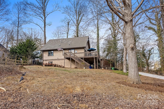 back of house with a wooden deck