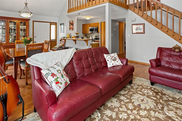 living room with vaulted ceiling and light hardwood / wood-style flooring