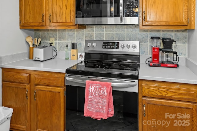 kitchen with stainless steel appliances and backsplash