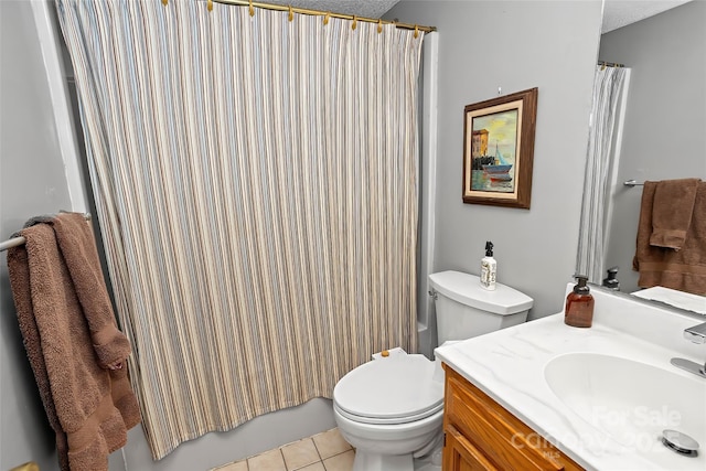 bathroom featuring vanity, tile patterned floors, a textured ceiling, and toilet