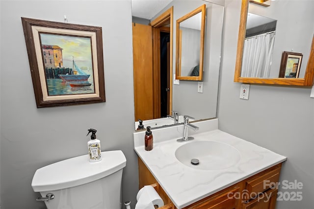 bathroom featuring vanity and toilet