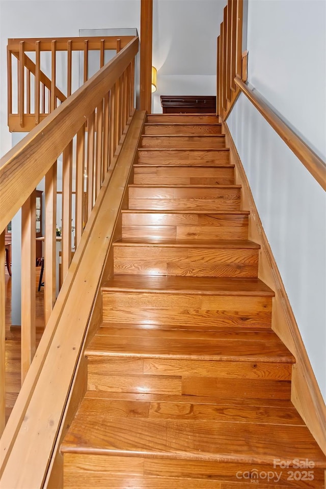 stairs featuring hardwood / wood-style flooring