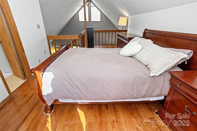 bedroom with lofted ceiling and light hardwood / wood-style flooring