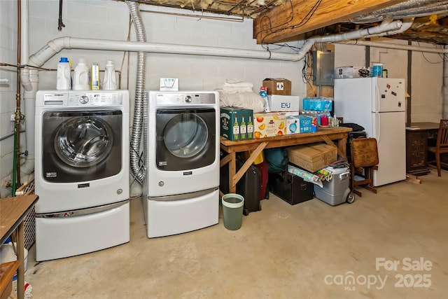 clothes washing area featuring washing machine and dryer and electric panel