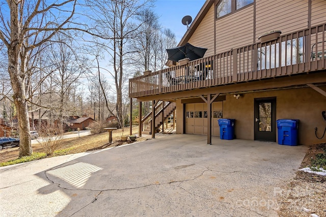 view of home's exterior with a garage and a wooden deck