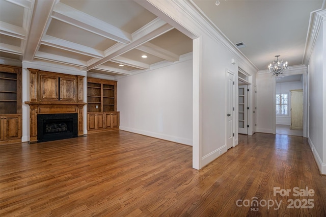 unfurnished living room featuring wood-type flooring, a chandelier, ornamental molding, coffered ceiling, and beam ceiling