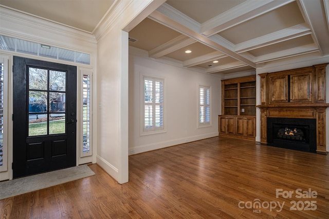 foyer entrance featuring coffered ceiling, hardwood / wood-style floors, crown molding, and beamed ceiling