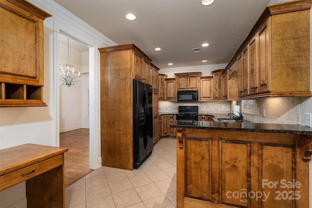 kitchen featuring light tile patterned floors, sink, tasteful backsplash, black appliances, and kitchen peninsula