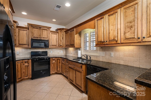 kitchen with light tile patterned flooring, crown molding, sink, and black appliances