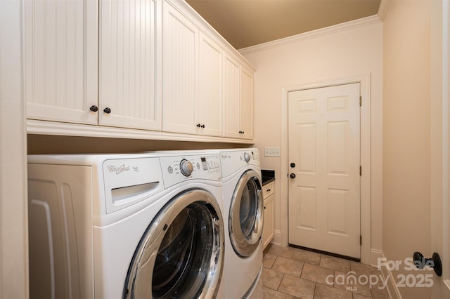 laundry room featuring washer and dryer, crown molding, and cabinets