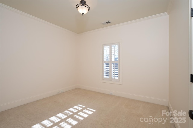 spare room featuring crown molding and light colored carpet