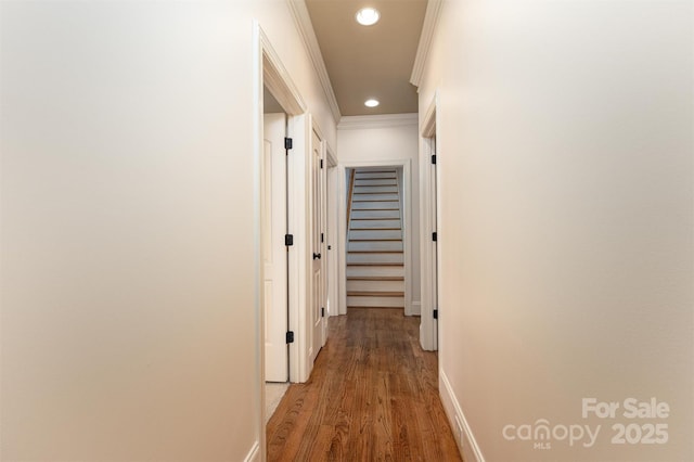 corridor featuring hardwood / wood-style flooring and ornamental molding