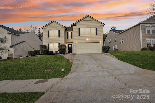 view of front property with a yard and a garage