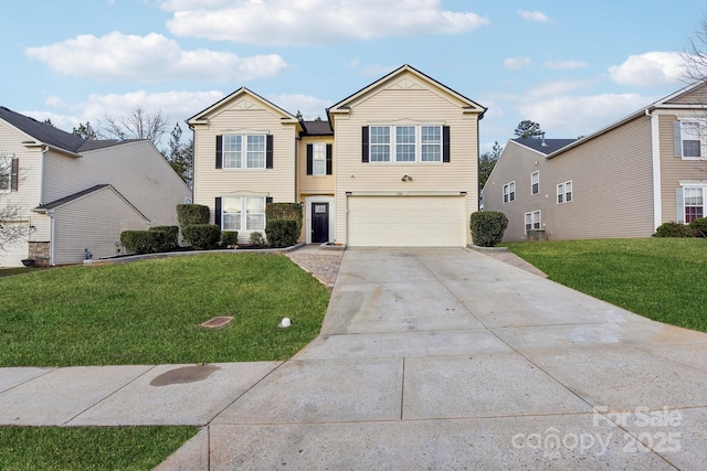 view of property with a garage and a front lawn