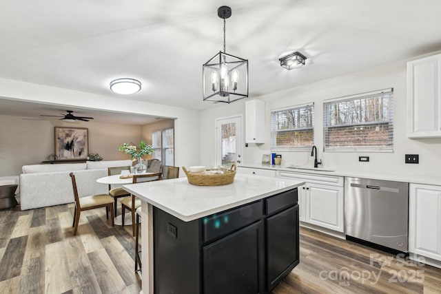 kitchen featuring sink, white cabinetry, a center island, dishwasher, and pendant lighting