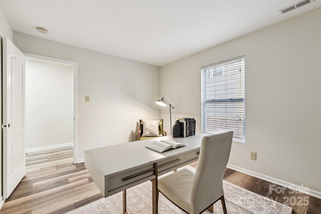 office with light wood-type flooring