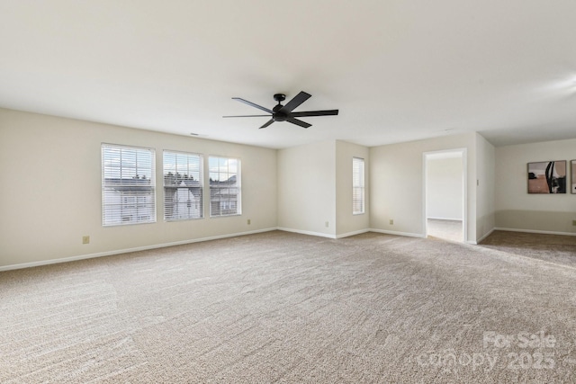 carpeted spare room with ceiling fan