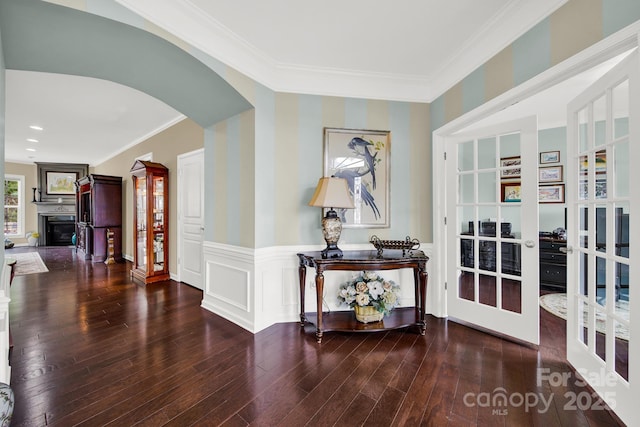 corridor featuring french doors, ornamental molding, and dark hardwood / wood-style flooring