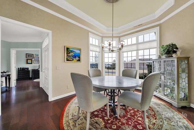 dining room with an inviting chandelier, ornamental molding, and dark hardwood / wood-style floors