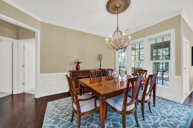 dining space with ornamental molding, dark hardwood / wood-style flooring, and a chandelier