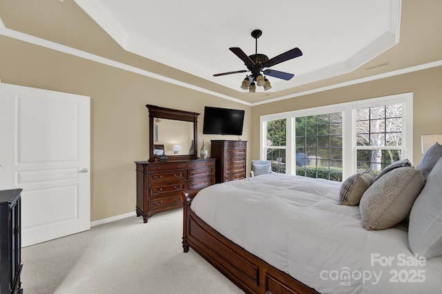 bedroom with ornamental molding, light colored carpet, a raised ceiling, and ceiling fan