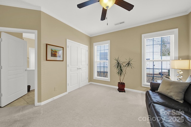 living area featuring crown molding, light colored carpet, and ceiling fan