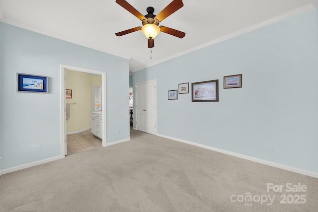 interior space with ceiling fan and ornamental molding