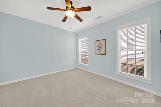 unfurnished room with light carpet, crown molding, and a wealth of natural light