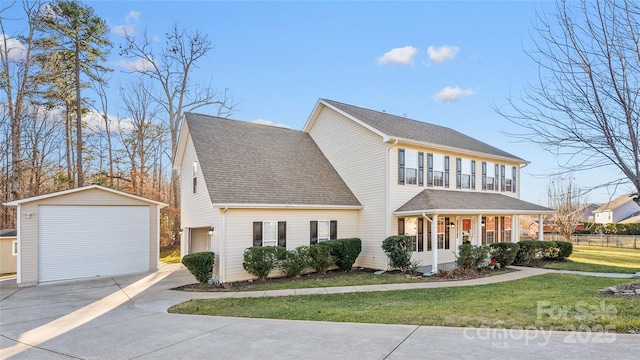 view of front of home with an outbuilding, a garage, a front lawn, and a porch