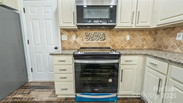 kitchen featuring light stone counters, tasteful backsplash, dark hardwood / wood-style floors, and appliances with stainless steel finishes