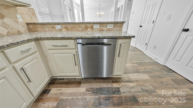 kitchen with dishwasher, backsplash, light stone counters, and cream cabinetry