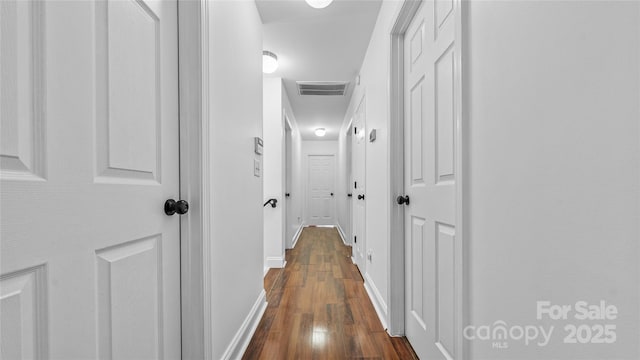 hallway featuring dark hardwood / wood-style flooring